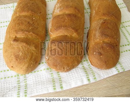 Freshly Baked Spelt Baguette On A Dishtowel