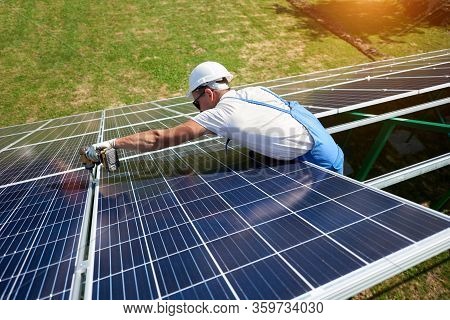 Wearing Protective Helmet, Mounter Installing Solar Panels On Roof. Ecological Friendly, Nature Savi