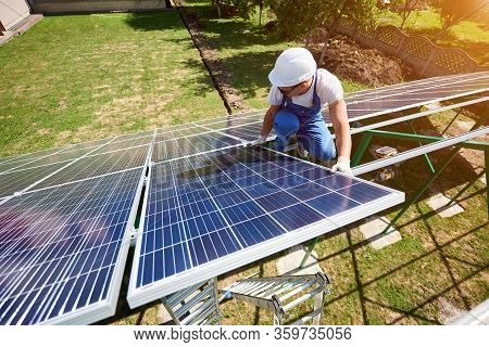 Professional Mounter Installing Innovative Solar Panels. High-tech Exterior, Modern Equipment, Ecolo