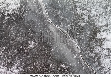 Texutured Ise Surface Of Frozen Lake. Close Up. Scattered White Snow Around. Winter Background.
