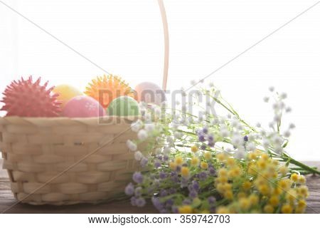 Virus Model Of Coronavirus Disease Covid-19 With Colorful Easter Eggs In Basket With Flowers On A Wo