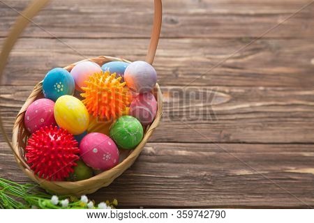 Virus Model Of Coronavirus Disease Covid-19 With Colorful Easter Eggs In Basket With Flowers On A Wo
