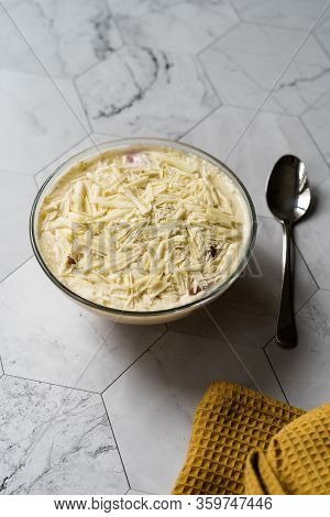 Profiteroles With White Chocolate In Glass Bowl.