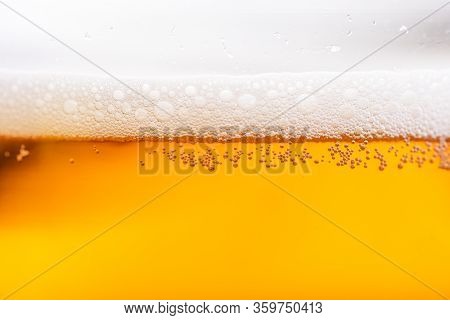 Light Beer With Bubbles And Foam Background. Beer Bubbles Texture Close Up.