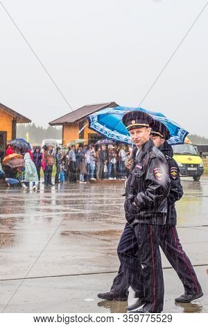 Kogalym, Russia - 06.16.2018: Sabantui Celebration Event On A Rainy Day, Police Officers Guard The T