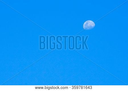 Half Moon In Sunny Day Isolated On The Blue Sky Background