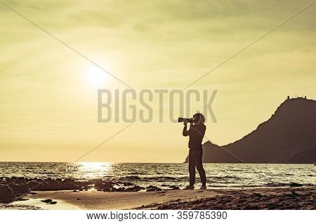 Tourist Woman With Camera Taking Travel Photo On Monsul Beach At Sunset. Cabo De Gata Nijar Natural 