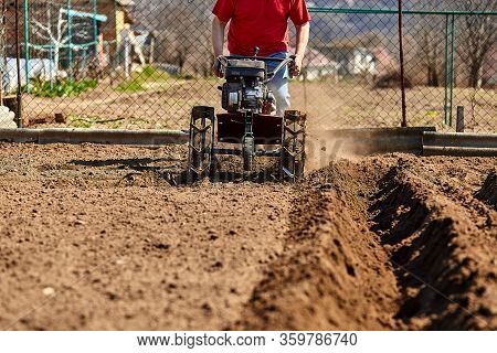 Gardener Cultivate Ground Soil With Tiller Tractor Or Rototiller, Cutivator