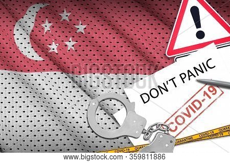 Singapore Flag And Police Handcuffs With Inscription Dont Panic On White Paper. Coronavirus Or 2019-