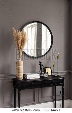 Console With A Mirror On A Background Of A Gray Wall In A Modern Interior.