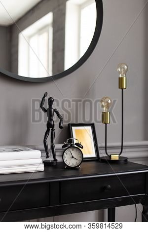Console With A Mirror On A Background Of A Gray Wall In A Modern Interior. Close Up.