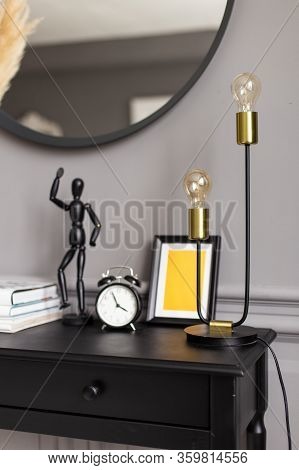 Console With A Mirror On A Background Of A Gray Wall In A Modern Interior. Close Up.