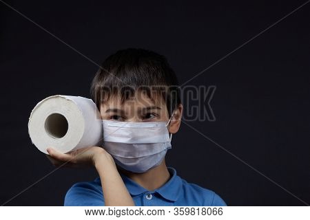 A Child In A Protective Mask Holding Toilet Paper Napkins