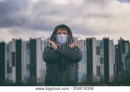A Man In A Medical Mask On The Background Of An Urban Area