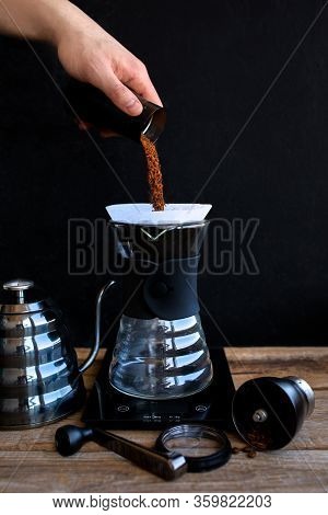 Ground coffee in the funnel.The ritual of making coffee.Making coffee at home.Filtered or overflow i