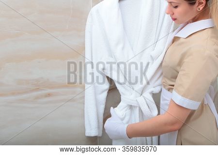 White Terry Dressing Gown In The Bathroom. The Concept Of Development Of Hotel Business. A Copy Of T