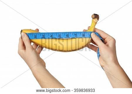Measuring The Size Of A Banana As A Symbol Of The Male Penis Isolated On White Background. Big Dick 