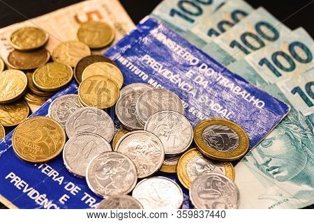 Old Work Card From Brazil, Old And Handled Document. Beside Real Coins, Brazilian Money. Concept Of