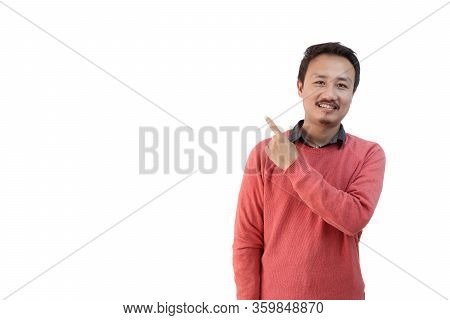 A Man In Pink Sweater Isolated In White Background Pointing Finger Towards A Blank Copy Space Area