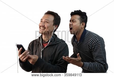 A Man Listening To Music While Another Man Shouting In Anger To Gain His Attention