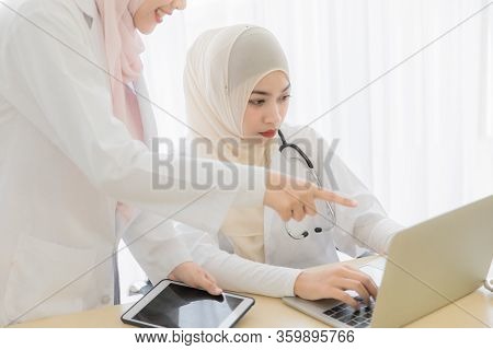 Two Attractive Young Beautiful Female Muslim Doctor Covered Face With Hijab Dress Talking With Famil