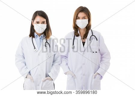 Two Female Doctors Wearing Surgical Protective Hygiene Mask Standing Together Isolated On White Back
