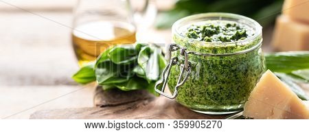 Wild Leek Pesto With Olive Oil And Parmesan Cheese In A Glass Jar On A Wooden Table. Useful Properti