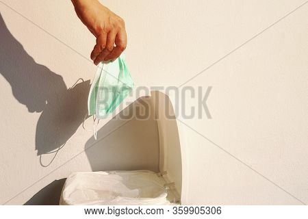 His Hand Picks Up Things Without Protection From Germs.
The Disposal Of Surgical Masks A Used Incorr