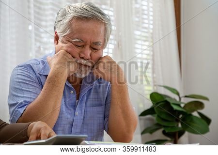 Asian Senior Man Thinking About Something And Worried Or Stress