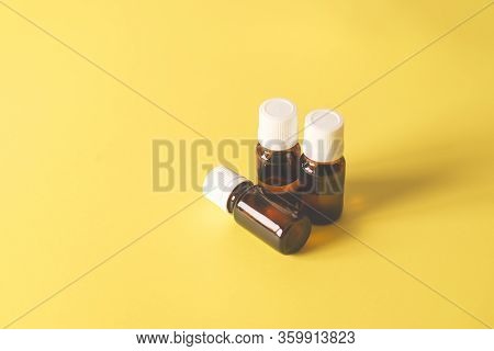 Beautifully Set Glass Medicine Bottles On A Yellow Background For Your Design Or Medical Article