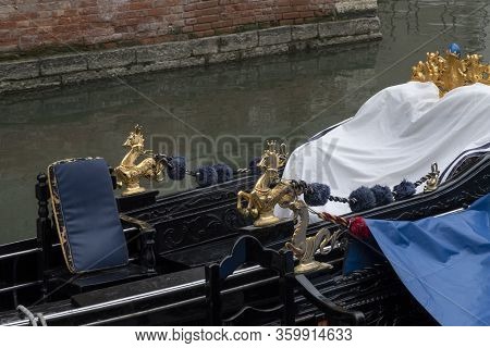 Detail Of Venetian Gondola In Green Canal Waters Of Venice Italy