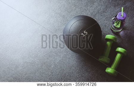 Top View Of The Green Drumbell, Slamball And Water Bottle With Copy Space. Sport And Recreation Conc