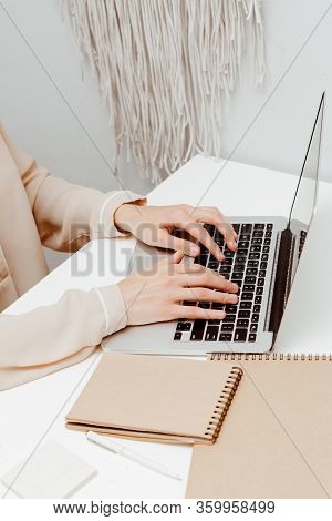 Home Office. The Girl Is Working On A Laptop At Home