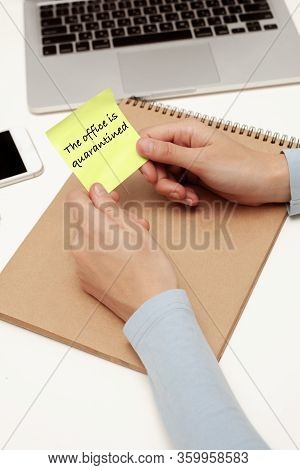 Hands Hold A Piece Of Paper With An Inscription. Quarantine Message7 Work From Home.