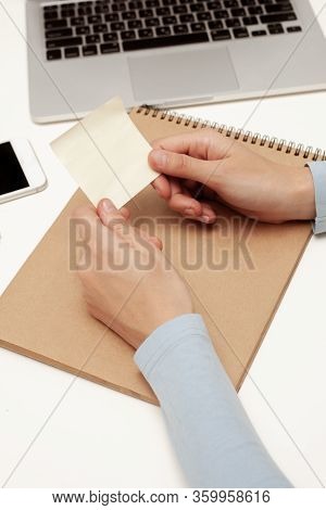 An Office Worker Holds An Empty Sticker With His Hands. Empty Space For The Text.