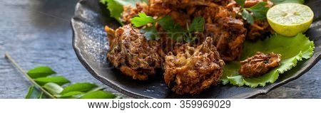 Indian Cuisine Indian Food. Pakora Traditional Indian Deep-fried Snack. Pakoras On Black Plate With 
