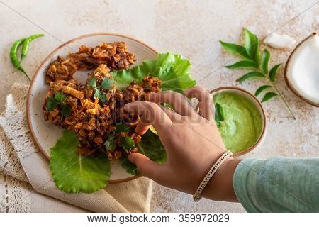 Indian Cuisine Indian Food. Pakora With Coconut Chutney Sauce Curry Leaves. Hand Of Young Indian Wom