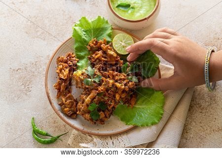 Indian Cuisine Indian Food. Pakora With Coconut Chutney Sauce Curry Leaves. Hand Of Young Indian Wom