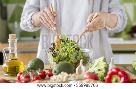 Raw Vegan Food Ration. Young Woman Mixing Salad In A Bowl And Adding Olive Oil, Healthy Lifestyle
