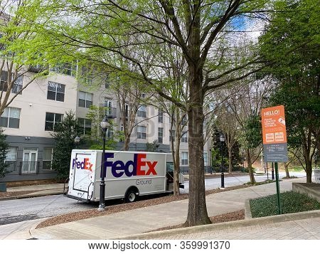 Atlanta, Ga/usa-3/21/20:  A Fedex Truck Delivering Package To Condominiums And Corporate Buildings I