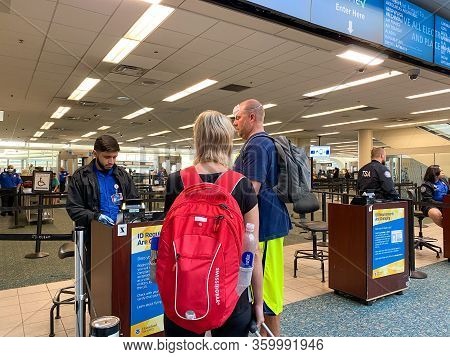 Orlando,fl/usa-3/21/20:  People Going Through Orlando International Airport Mco Tsa Security In Mask