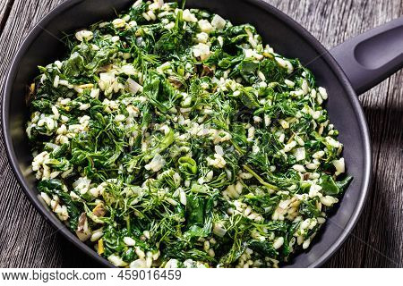 Close-up Of Spanakorizo, Greek Spinach And Rice Pilaf With Lemon, Dill, Scallion In Frying Pan On Da