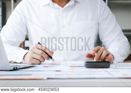 Investors Are Calculating Profits And Costs With Calculators, Growth And Investment Chart Analysis, 