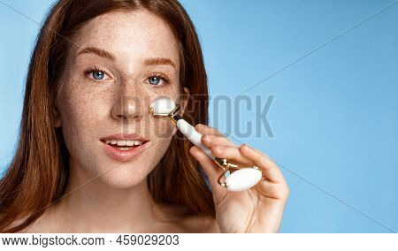 Gua Sha Face-lift. Happy Smiling Redhead Woman Close Her Eyes, Using Guasha Jade Stone Roller For Ma