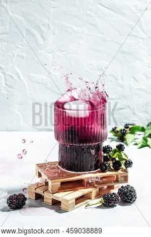 Black Berry Mojito Or Lemonade With Blac Kberry And Ice Freeze Motion Splash Drops On A Light Backgr