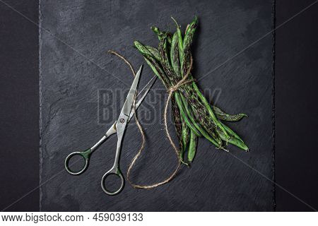 String Beans On A Black Background. A Bunch Of Raw Green Beans Tied With A Rope. Healthy Vegetable