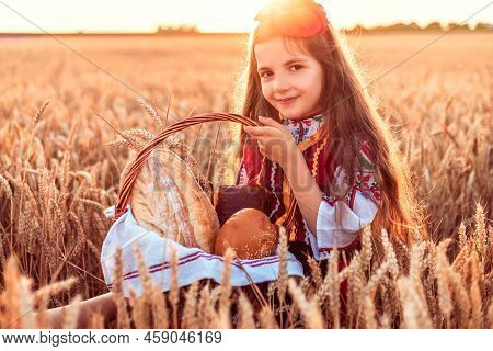 Bulgarian Woman, Young Girl In Traditional Folklore Dress Holds In Hands Golden Wheat And Freshly Ba