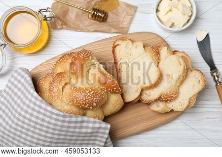 Cut Freshly Baked Braided Bread, Honey And Butter On White Wooden Table, Flat Lay. Traditional Shabb