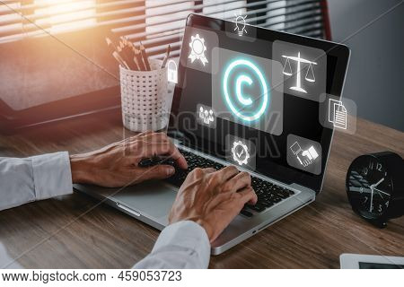 Copyright Or Patent Concept, Person Hand Using Laptop Computer On Desk With Vr Screen Copyright Icon