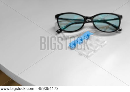 Single Dose Eye Drops, Glasses And Fabric On White Table, Space For Text
